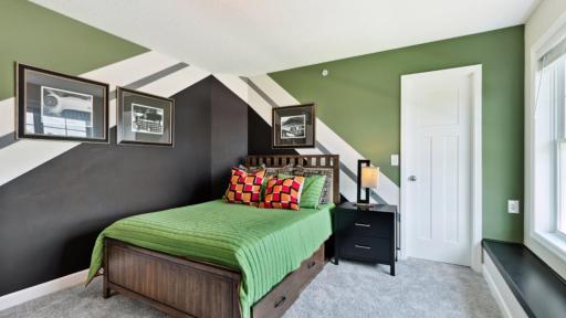 (Photo of a decorated model, actual homes finishes will vary) Located on the second floor, this secondary bedroom features a built-in window seat and walk-in closet.