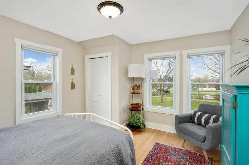 Second bedroom offers a cozy ambiance with ample natural light streaming in through multiple windows.