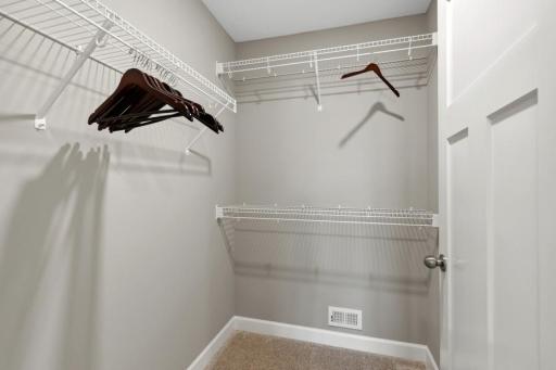 (Photo of a model, actual homes finishes will vary) The owner's suite features an incredible walk-in closet.