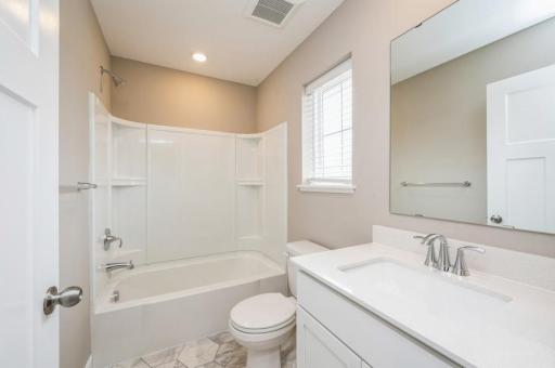 (Photo of a similar home, actual homes finishes will vary) This secondary bath is sure to keep everyone moving during those busy mornings!