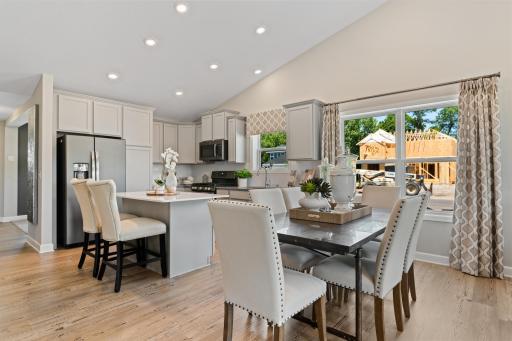 (Photo of decorated model, actual home's finishes may vary slightly) Welcome to the Courtland II! Soaked in natural sunlight, the homes eat-in dining room has ample space for a dining table located in the heart of the home.