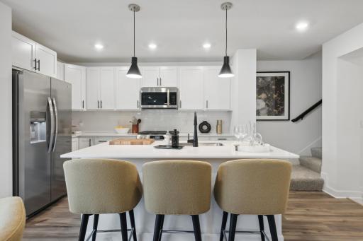 (Photo of model, actual features may vary) The kitchen has pendant lighting and an island perfect for cooking and entertaining