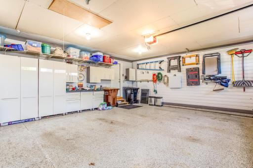 This spacious finished and insulated garage doubles as a functional workspace, featuring extensive storage solutions and a neat arrangement that maximizes the utility and versatility of the space.