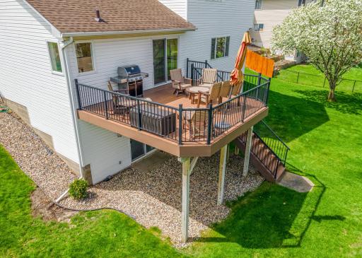 The maintenance-free deck serves as a focal point for outdoor dining and leisure, overlooking the serene neighborhood.