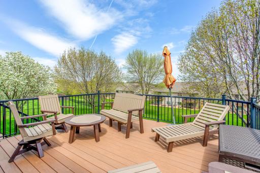 The maintenance-free deck serves as a focal point for outdoor dining and leisure, overlooking the serene neighborhood.