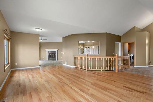 The living room has new hardwood floors and overlooks the open stairway to the walkout level.