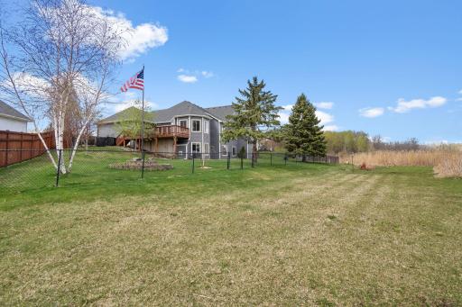 The large fenced yard is perfect for children and pets. The mowed grass beyond is part of the property too!
