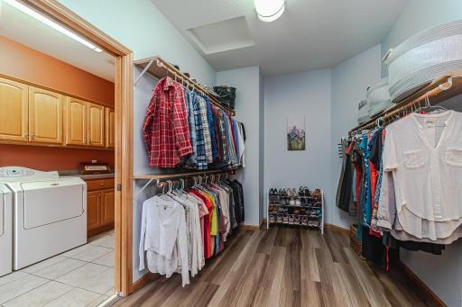 Master closet with pocket door to laundry. Storage galore
