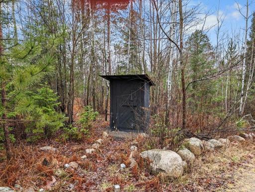 The outhouse is located about half way up the back driveway.