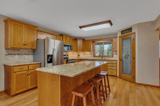 The kitchen features granite countertops new in 2019, tiled backsplash new in 2014, and mission style cabinetry throughout.
