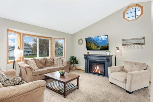 Living room is light and bright! (Fireplace not included in sale.)