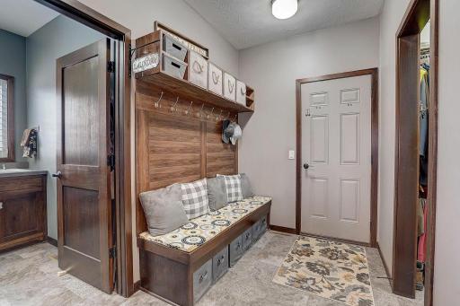 Custom built mudroom bench welcomes you in off your garage!