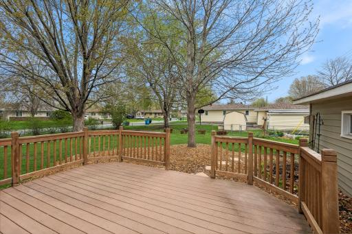 Huge deck off the dining room with maintenance free flooring and step-stones leading to the back yard.