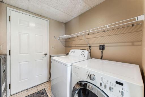 Laundry/mudroom conveniently located just off the kitchen on the main floor with entrance to the attached 2-car garage with shelves and workbench
