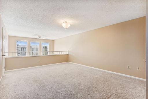Huge loft area overlooking living room below - perfect for an office, family room, or flex space!