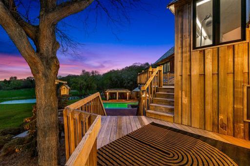 The in-ground pool is surrounded with paver patios and offers stunning views of the sprawling property.