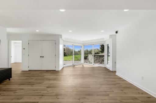 Natural light fills the entire lower level through the abundant floor to ceiling windows.