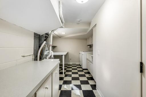 The main level laundry room offers additional storage.