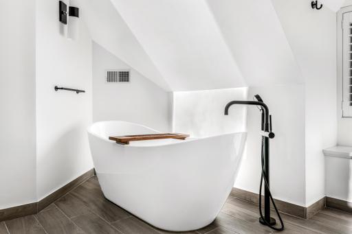 The large primary bathroom is completely updated with heated floors, a heated towel rack, an eco-friendly combination bidets/toilet with heated seat, a spacious, walk-in shower and luxurious soaking tub.