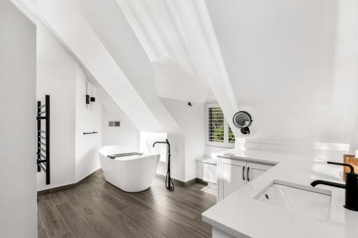 The large primary bathroom is completely updated with heated floors, a heated towel rack, an eco-friendly combination bidets/toilet with heated seat, a spacious, walk-in shower and luxurious soaking tub.