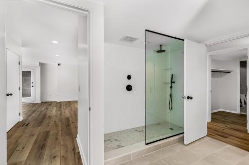 The second of 2 lower level bathrooms that have been completely updated including a large, tiled shower, double vanity, towel warmer and more.