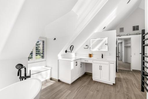 The large primary bathroom is completely updated with heated floors, a heated towel rack, an eco-friendly combination bidets/toilet with heated seat, a spacious, walk-in shower and luxurious soaking tub.