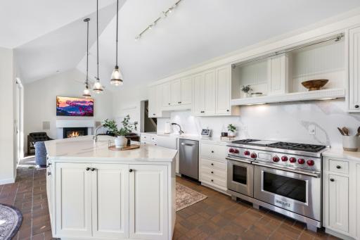 The beautifully updated kitchen includes pendant light fixtures, painted cabinets, 2 new sinks, a new Bosch dishwasher, Vikings appliances including a trash compactor, range with 6 burners a griddle & double oven, quartz countertops and backsplash.