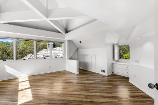 The primary bedroom features abundant natural light and stunning views.