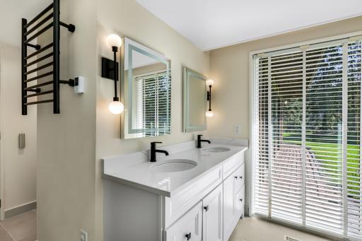 The second of 2 lower level bathrooms that have been completely updated including a large, tiled shower, double vanity, towel warmer and more.