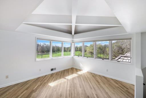 The primary bedroom features abundant natural light and stunning views.