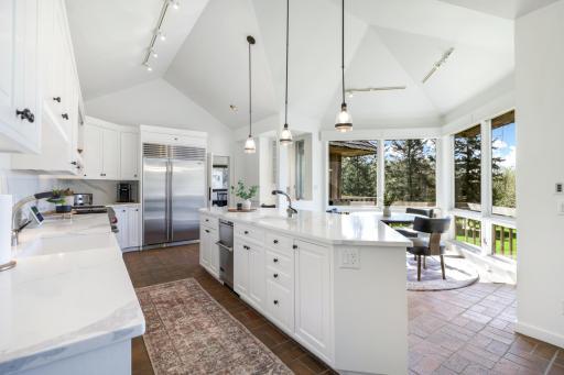The kitchen is bright and open to the informal dining space and family room space.