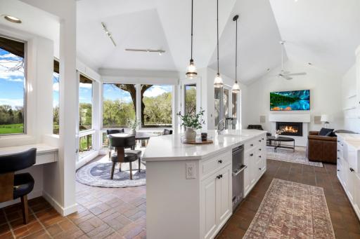 The beautifully updated kitchen includes pendant light fixtures, painted cabinets, 2 new sinks, a new Bosch dishwasher, Vikings appliances including a trash compactor, range with 6 burners a griddle & double oven, quartz countertops and backsplash.