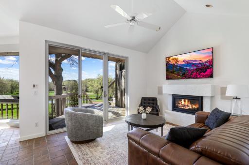 Guests and family are near to the kitchen in the cozy adjoining family room with gas fireplace.