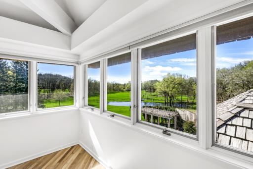The primary bedroom features abundant natural light and stunning views.