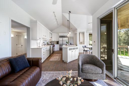 Guests and family are near to the kitchen in the cozy adjoining family room with gas fireplace.