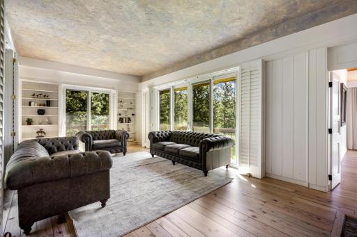 The main floor living room offers stunning views, custom built-ins and a cozy gas fireplace.