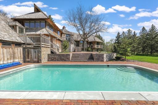 The in-ground pool looks out to the sprawling, beautiful property.