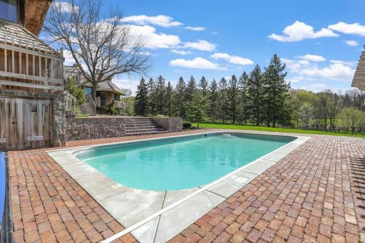 The in-ground pool looks out to the sprawling, beautiful property.