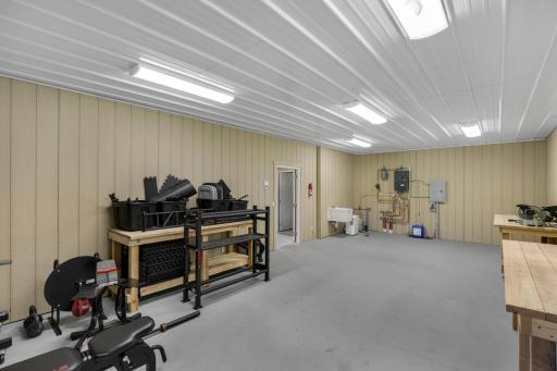 The nearly 3,000 square foot Morton building features a 32x30 foot heated workshop with boiler and in-floor heating, a water heater, half bathroom and 42x48 cold storage space with 3 overhead garage doors.