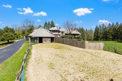 For equestrian enthusiasts, the property features riding trails, an outdoor arena, and a four-box stall barn with a feeding loft that is connected to the residence.