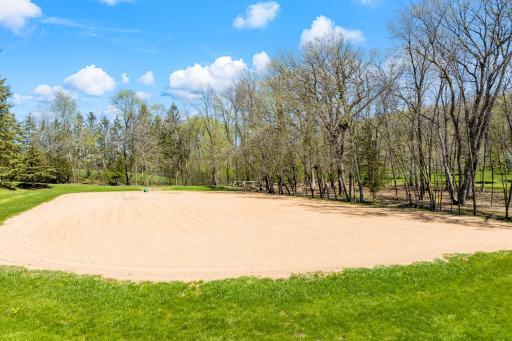 For equestrian enthusiasts, the property features riding trails, an outdoor arena, and a four-box stall barn with a feeding loft that is connected to the residence.