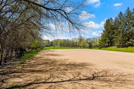 For equestrian enthusiasts, the property features riding trails, an outdoor arena, and a four-box stall barn with a feeding loft that is connected to the residence.