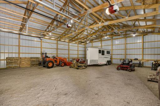 The nearly 3,000 square foot Morton building features a 32x30 foot heated workshop with boiler and in-floor heating, a water heater, half bathroom and 42x48 cold storage space with 3 overhead garage doors.