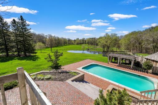 The in-ground pool looks out to the sprawling, beautiful property.