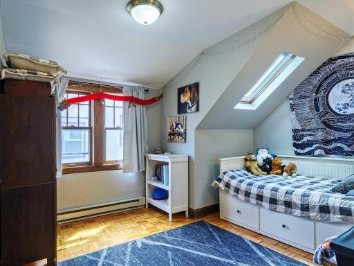 One of 2 bedrooms on upper level. Parquet floors and new sky light for additional natural light.