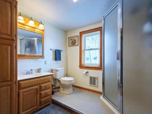 Upper level 3/4 bath has walk-in shower, new toilet and beautiful tile flooring. Linen closet and medicine cabinet.
