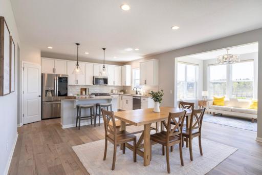 Open concept Living Room/Dining/Kitchen, dining leads to the sunroom. A complete kitchen with an oversized Quartz coated island, pantry closet, SS appliances, vented microwave hood and gas range, and enough space around for the chef to roam about!