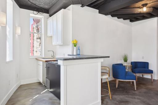 Take your time as you soak in all the features of the wet bar. Massive dual slide top cooler, ice maker, stone counter, custom cabinetry and millwork, dishwasher, and views of the pool from the bar.
