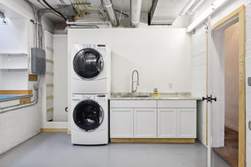 The conveniently located walkout laundry room with utility sink is just steps away from the backyard patio oasis, making pool-party clean up a breeze.