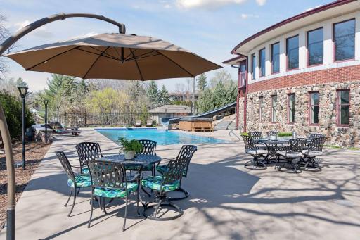 Spacious pool deck with ample room for outdoor grilling, dining, pick up basketball game and enough room for a ping pong table.